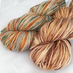 two coordinating skeins of brown and orange variegated yarn
