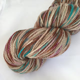 Skein of brown, teal, and magenta variegated yarn