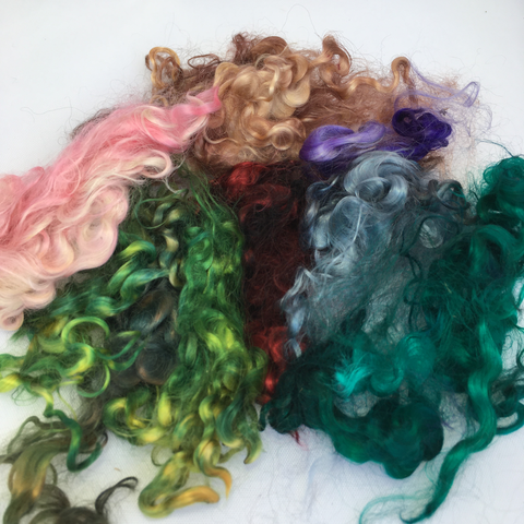 Several different colors of mohair locks for carding.